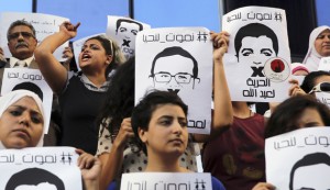 Protesters rally in support of Al Jazeera journalists Abdullah al-Shami and Mohammed Sultan, who were detained by Egyptian authorities, in front of the Press Syndicate in Cairo